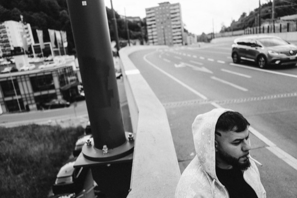 GABU hinter einem Mast an der Strasse, Schwarzweiss